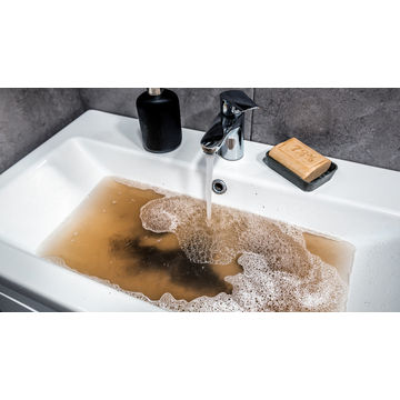 Cleaning clogged bathroom sink by Kwaramba electrical contractors